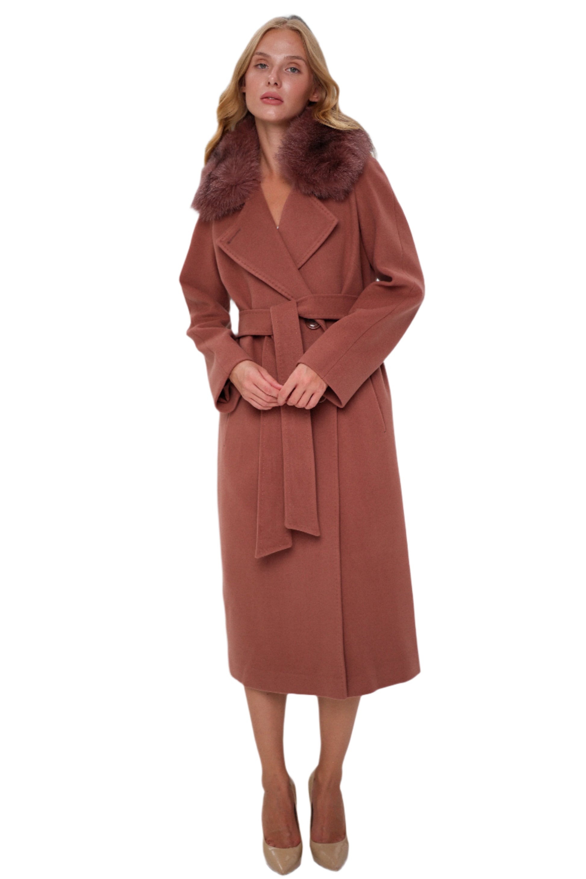 Woman wearing a long brown coat with a fur collar on a white background
