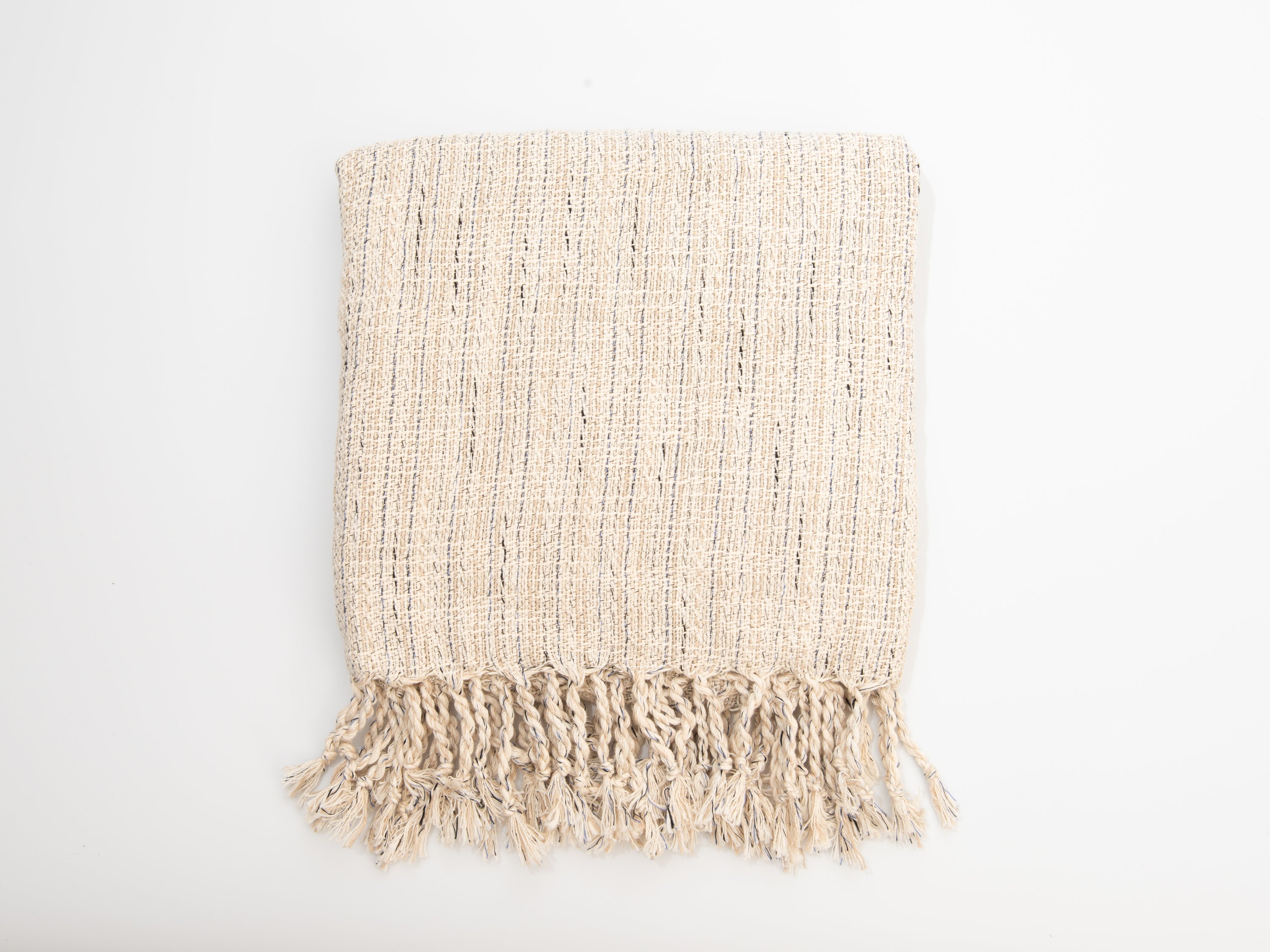Beige woven blanket with fringes on a white background