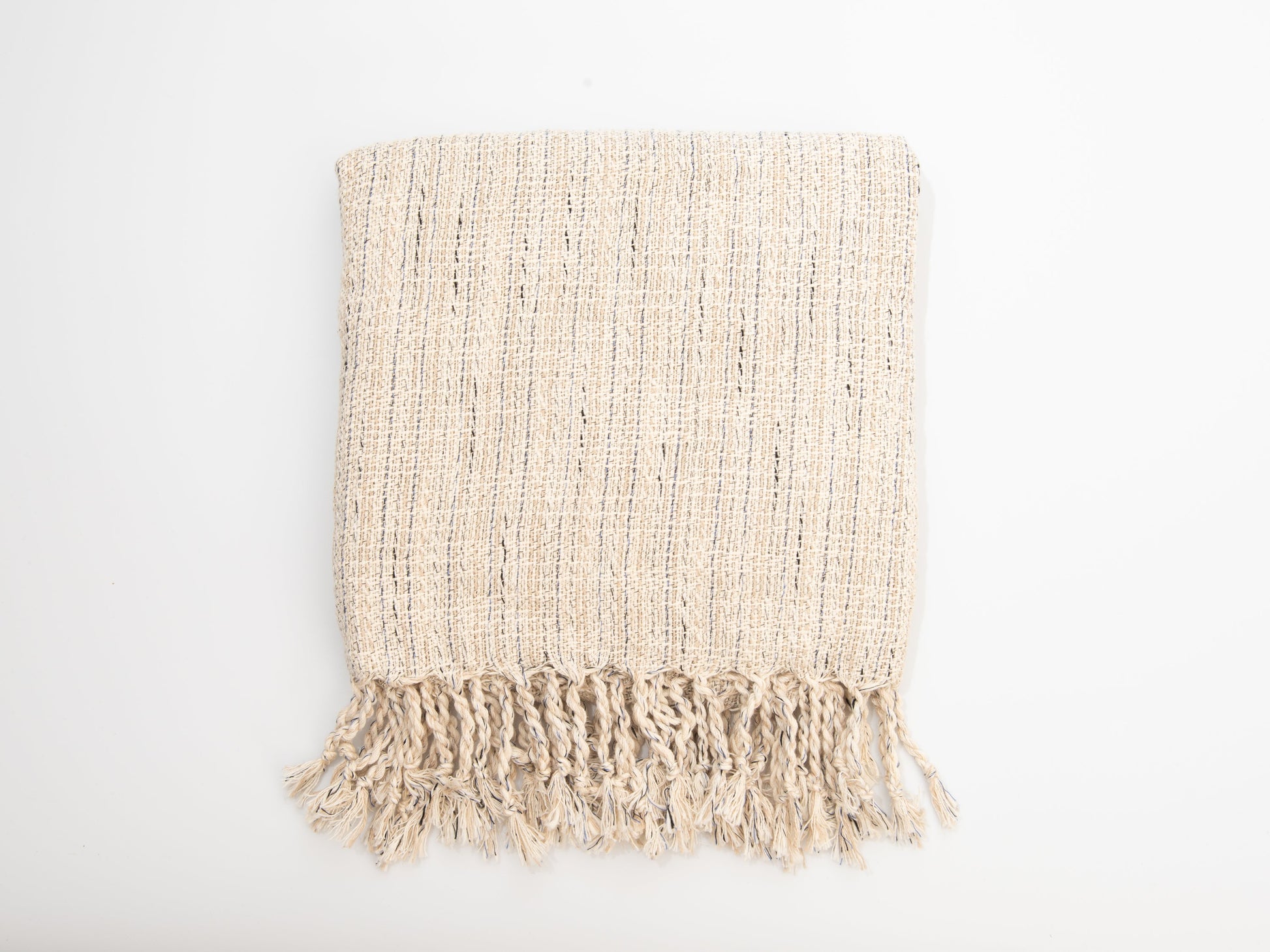 Beige woven blanket with fringes on a white background