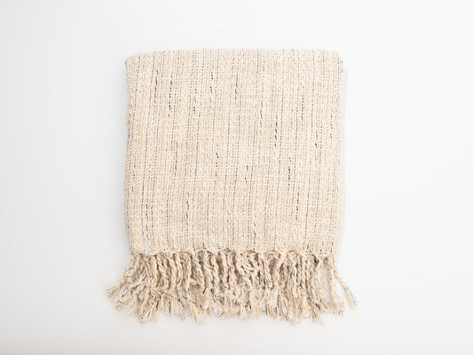 Beige woven blanket with fringes on a white background