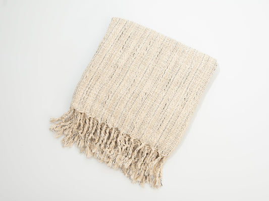 Beige woven blanket with fringes on a white background