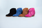 Four pairs of colorful fringe boots on a light gray background