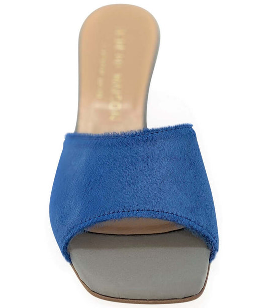 Blue sandal with a beige sole on a white background