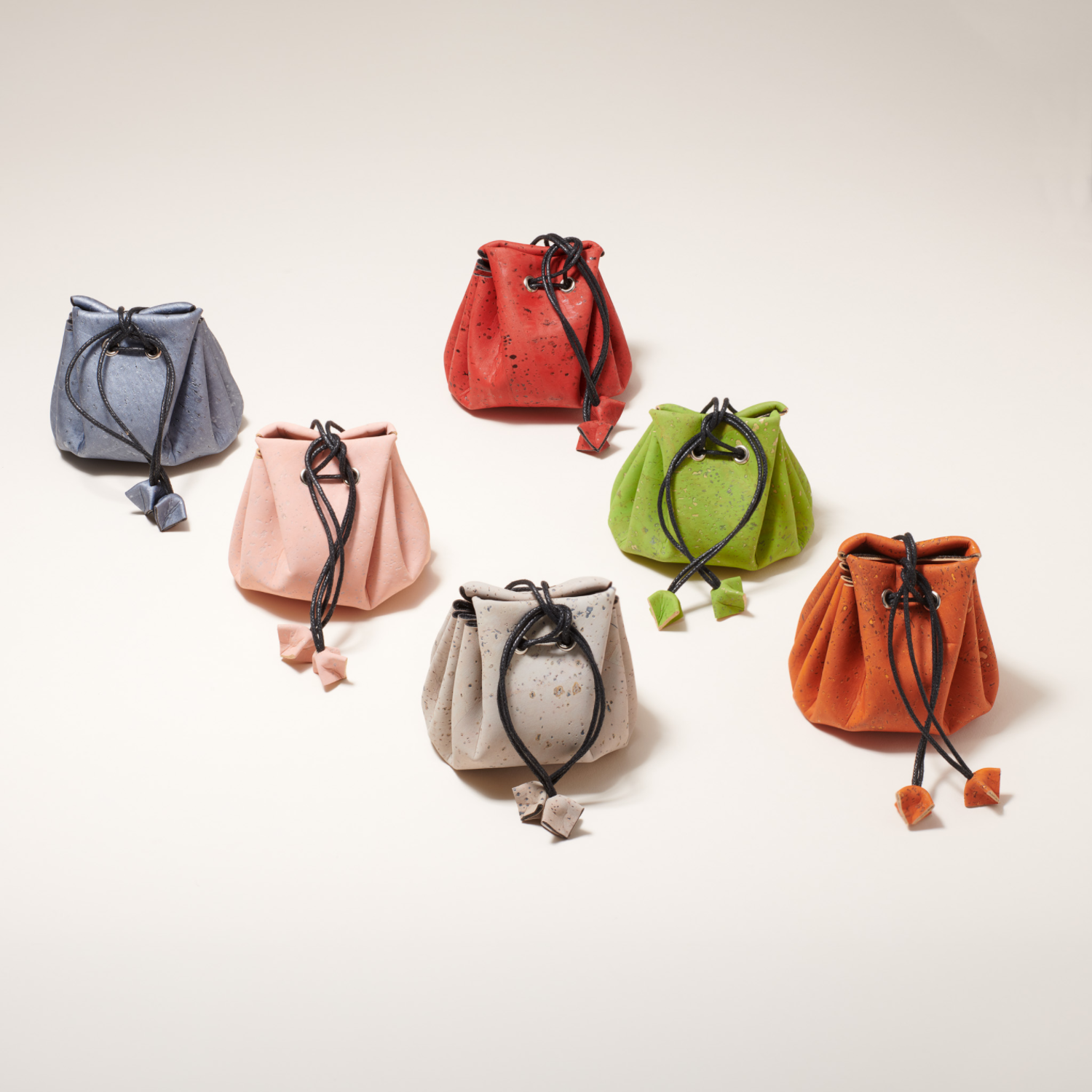 Set of colorful drawstring bags on a light background