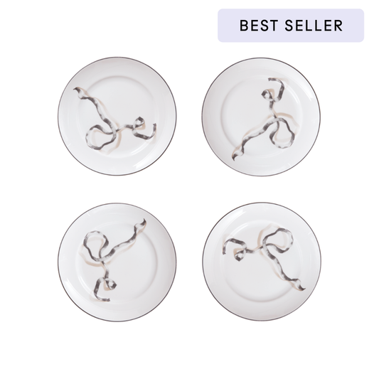 Four white plates with decorative elements on a white background, labeled 'Best Seller'.