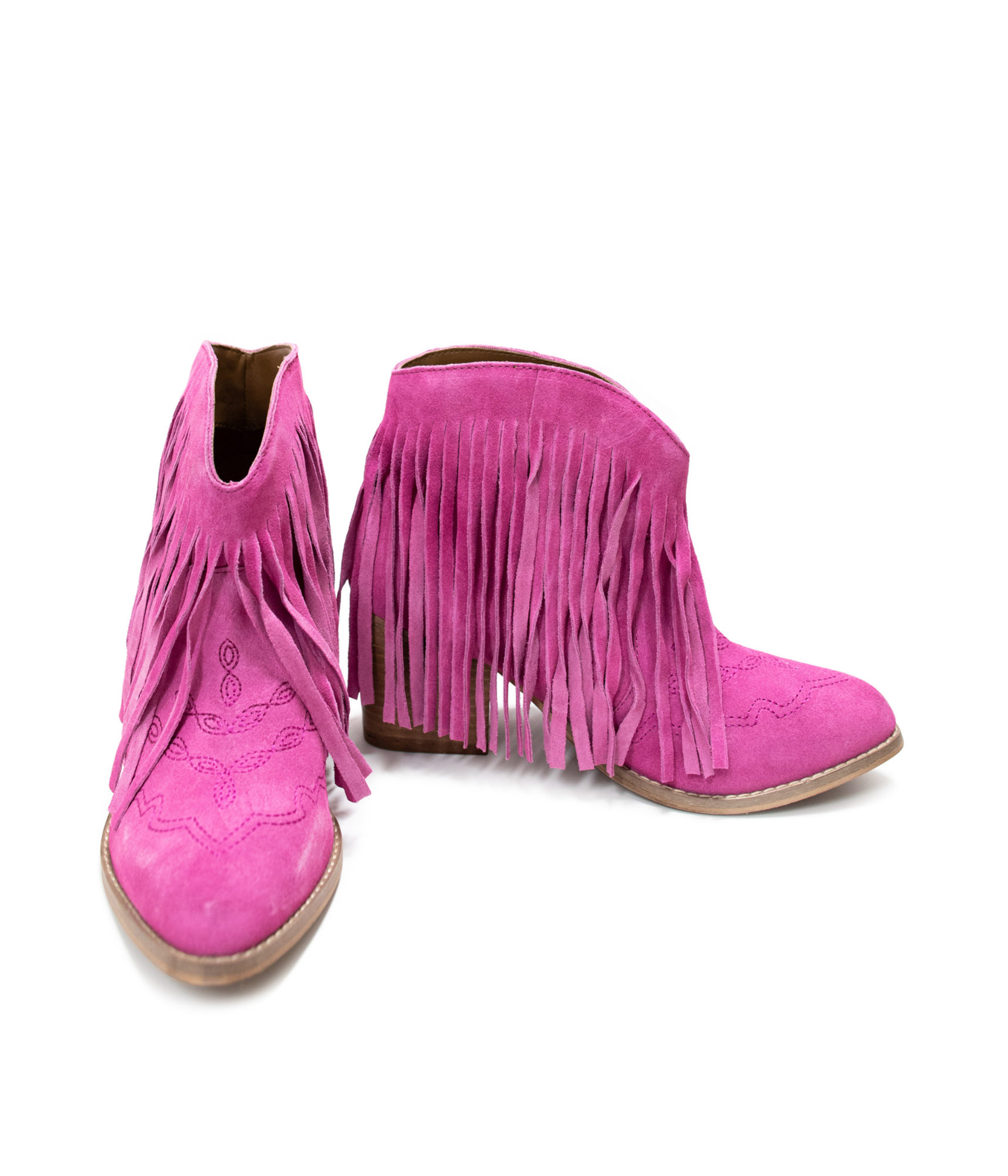 Pair of pink suede fringe boots on a white background