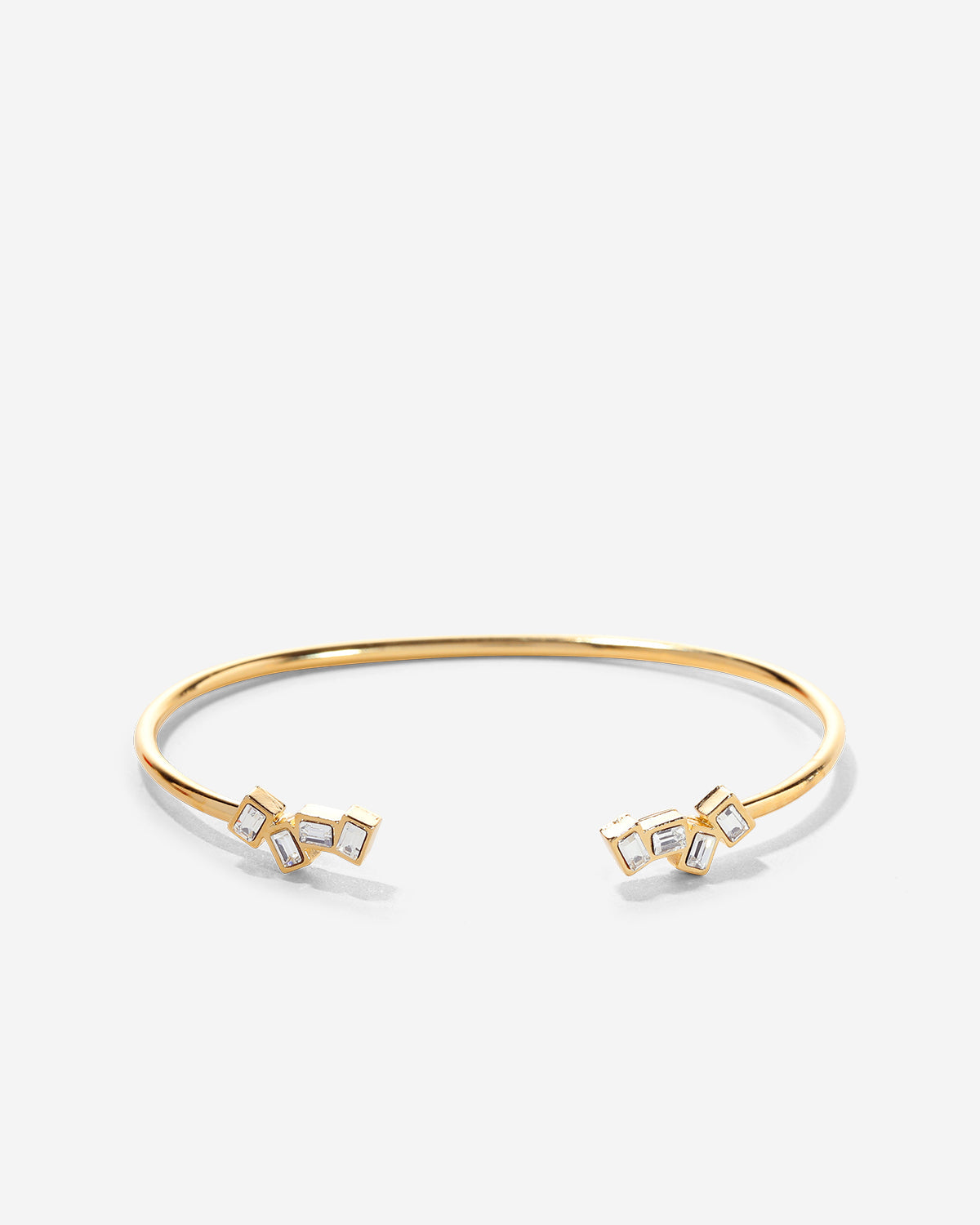 Gold bracelet with geometric designs on a white background