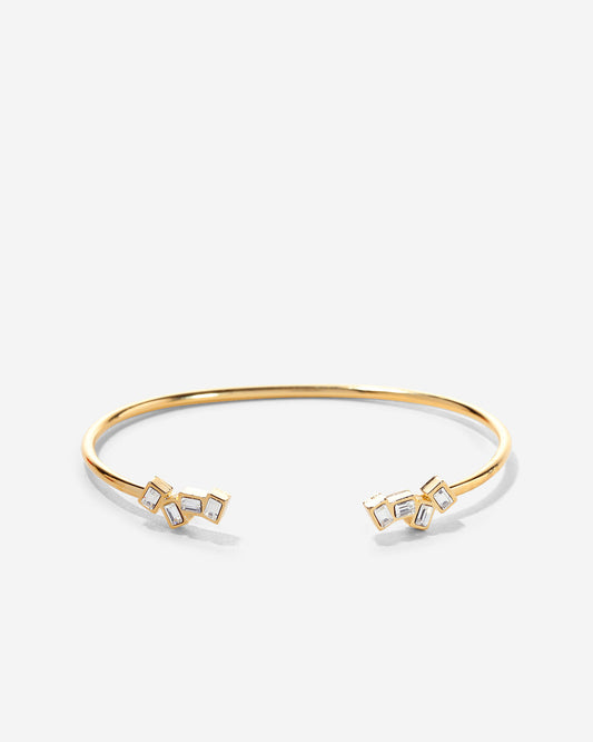Gold bracelet with geometric designs on a white background