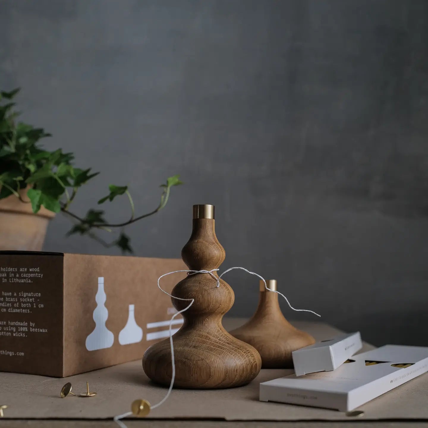 Wooden candle holders on a table with a dark background