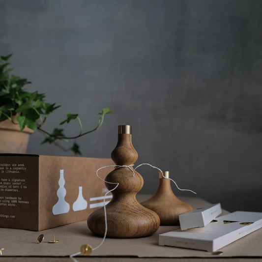 Wooden candle holders on a table with a dark background