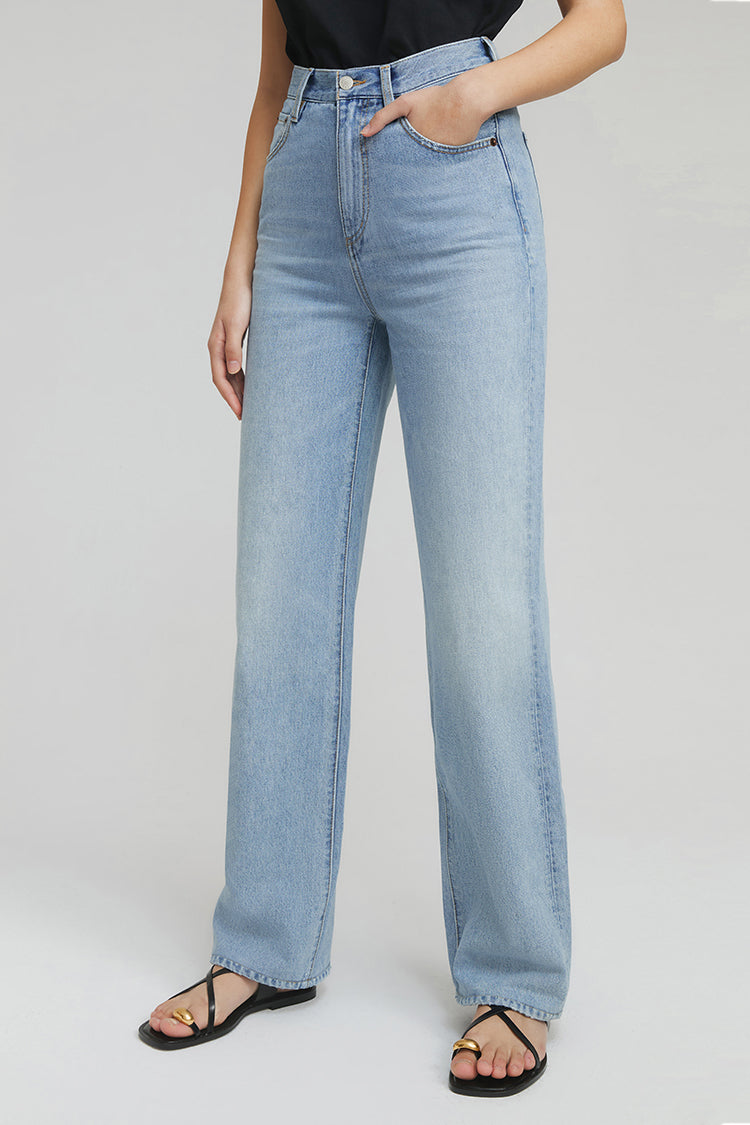 Light blue jeans worn by a person on a white background